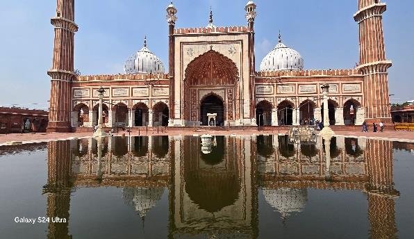 Jama Masjid reflected in its courtyard pool in Old Delhi