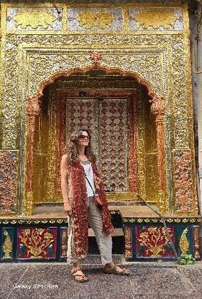 Visitor at an ornate historic haveli doorway in Chandni Chowk